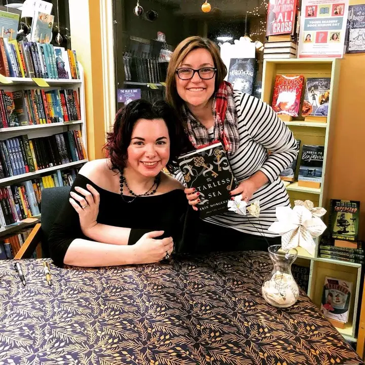 Toni Rocchetti at a bookstore event holding a copy of The Starless Sea