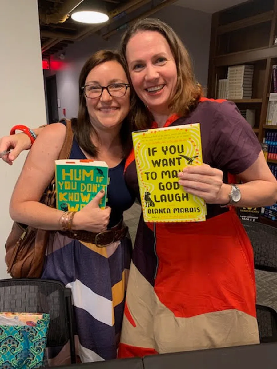 Toni Rocchetti at a book event holding Hum If You Don't Know the Words